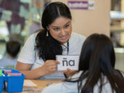 Ruth Bader Ginsburg Elementary School teacher Mellissa Barlas works with a student while using flashcards during class on Tuesday morning.