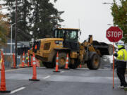 Construction crews work to install a new waterline along Northeast 112th Avenue on Monday morning.