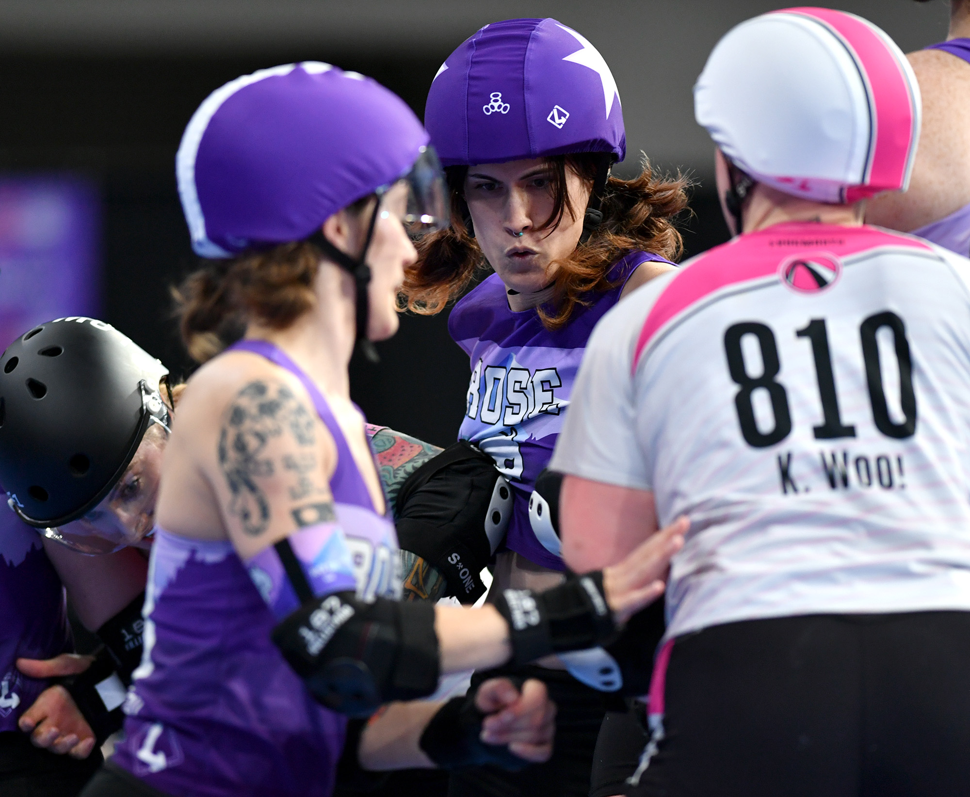 Rose City Rollers jammer  Springroll, center, moves through the pack Sunday, Nov. 3, 2024, during the Women’s Flat Track Derby Association Global Championships at Veteran’s Memorial Coliseum in Portland. Rose City Rollers’ Wheels of Justice won their fifth overall title 141-104 against Arch Rival All Stars from St. Louis, Mo.