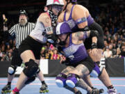 Rose City Rollers&rsquo; Mia Palau (247) falls between teammate Tarantula (401) and Arch Rival jammer Vicious Van GoGo (1543) on Sunday during the Women&rsquo;s Flat Track Derby Association Global Championships at Veterans Memorial Coliseum in Portland. Rose City Rollers&rsquo; all-star team, Wheels of Justice, won its fifth overall title 141-104 against Arch Rival All Stars from St. Louis, Mo.