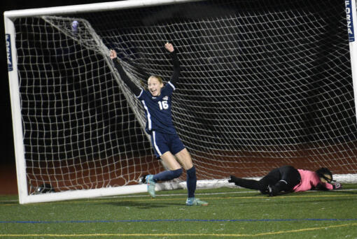 Shaylie Haij (16) of King's Way Christian celebrates after shooting the ball past Rochester goalkeeper Alondra Uribe for a goal against Rochester with teammates Cozette Silva (right) and Addison Bagley (18) during a Class 1A girls soccer district playoff game at King's Way Christian School on Tuesday, Nov. 5, 2024.