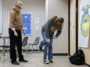 Science teacher Jill Cole, left, looks on as junior Bailey Fling, 16, tries out the prosthetic leg she created during her careers in science class at La Center High School on Thursday morning.