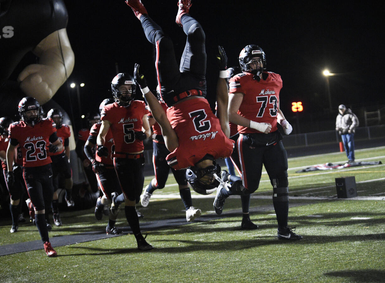 Titan Brody (2) of Camas does a flip as the Camas football team enters the field to play Stadium in a 4A state preliminary football game at Doc Harris Stadium in Camas on Friday, Nov. 8, 2024.