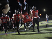 Titan Brody (2) of Camas does a flip as the Camas football team enters the field to play Stadium in a 4A state preliminary football game at Doc Harris Stadium in Camas on Friday, Nov. 8, 2024.