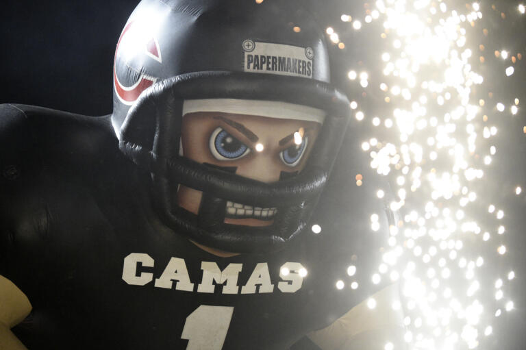 Sparks go off in front of the Papermaker inflatable before a 4A state preliminary football game between Camas and Stadium at Doc Harris Stadium in Camas on Friday, Nov. 8, 2024.