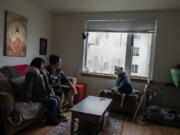 Katie Vongthongthip of Vancouver, left, joins her fiance, Chance Newbill, as they enjoy time with their dog, Nova, at their apartment in Isabella Court II.