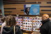 People look at photos of transgender individuals who died due to suicide or acts of anti-trans violence in the past two years during Wednesday&rsquo;s Transgender Day of Remembrance ceremony.