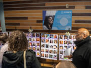 People look at photos of transgender individuals who died due to suicide or acts of anti-trans violence in the past two years during Wednesday&rsquo;s Transgender Day of Remembrance ceremony.