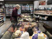 Karen Goritski of Camas selects a turkey while joining shoppers at the Fisher&rsquo;s Landing New Seasons Market the week before Thanksgiving. The day before Thanksgiving is the single busiest food shopping day nationwide.