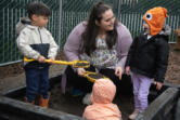 St. Johns Early Learning Center student Kani Dando, 4, from left, plays in a sandbox Monday with teacher-in-training Tia Thomas and student Daria Shenderovska, also 4. Thomas went through Educational Opportunities for Children and Families&rsquo; Parent University to work in early education.