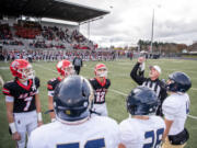 Camas, left, and Arlington captains watch the coin toss before a Class 4A state quarterfinal playoff game at Doc Harris Stadium in Camas on Saturday.