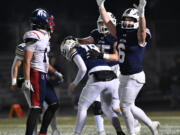 Seton players celebrate with Seton Catholic junior Dalton Woods (18) after Woods make the game-winning extra point Saturday, Nov. 23, 2024, during the Cougars’ 42-41 win against Life Christian Academy in the 1A State Football Playoff quarterfinals at Doc Harris Stadium in Camas.