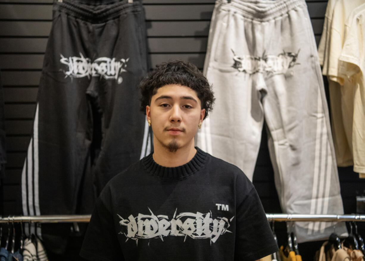 Clark College student Felix Cuevas, 19, sells clothes from his line at Mercury League in Vancouver Mall.