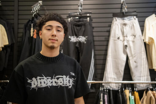 Clark College student Felix Cuevas, 19, sells clothes from his line at Mercury League in Vancouver Mall.