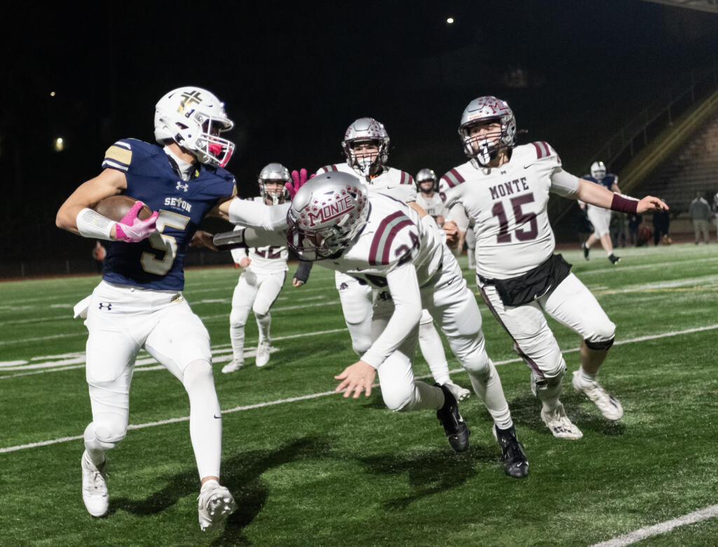 Seton Catholic senior Ryker Ruelas (5) stiff arms Montesano junior Kole Kjesbu (24) on Saturday, Nov. 30, 2024, during the Cougars’ 35-14 win against Montesano in a 1A semifinal playoff game at McKenzie Stadium.