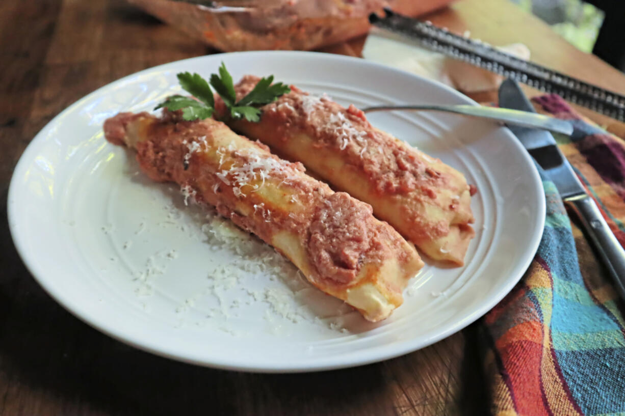 Homemade cheese and spinach manicotti with a spicy vodka sauce.