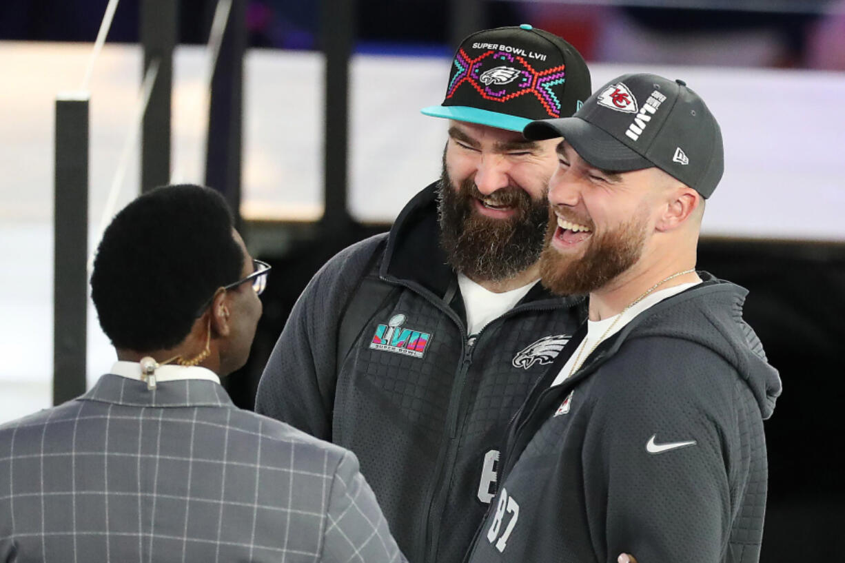 Eagles center Jason Kelce and Kansas City Chiefs tight end Travis Kelce, right, talk with Michael Irvin at the Super Bowl LVII Opening Night event in February. The brothers are recording a new Christmas album that includes harmonies from Boyz II Men.