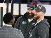 Eagles center Jason Kelce and Kansas City Chiefs tight end Travis Kelce, right, talk with Michael Irvin at the Super Bowl LVII Opening Night event in February. The brothers are recording a new Christmas album that includes harmonies from Boyz II Men.