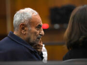 Viktor Pell looks over at his translator Oct. 28 during opening statements in the civil wrongful death trial filed by the family of Effie Entezari, who was killed in 1989. They believe the killer is Pell, the defendant in the trial. Entezari&rsquo;s husband, Mike Entezari, was previously convicted of her killing. He served 16 of his 25-year sentence before being released for good behavior and maintained his innocence for the rest of his life, according to the family.