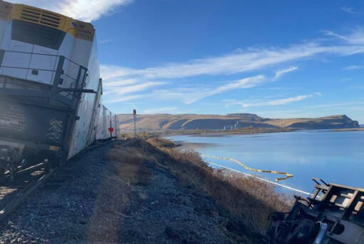 Rail cars slipped down the bank of the Columbia River early Wednesday, spilling diesel fuel near Tri-Cities.