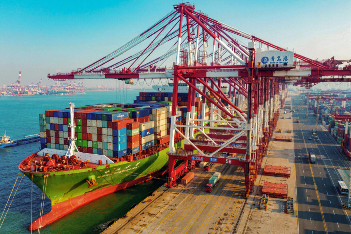 A cargo ship loaded with containers berths at a port in Qingdao, in China&rsquo;s eastern Shandong province, on Jan. 14, 2020.