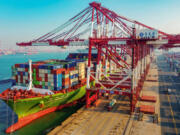 A cargo ship loaded with containers berths at a port in Qingdao, in China&rsquo;s eastern Shandong province, on Jan. 14, 2020.