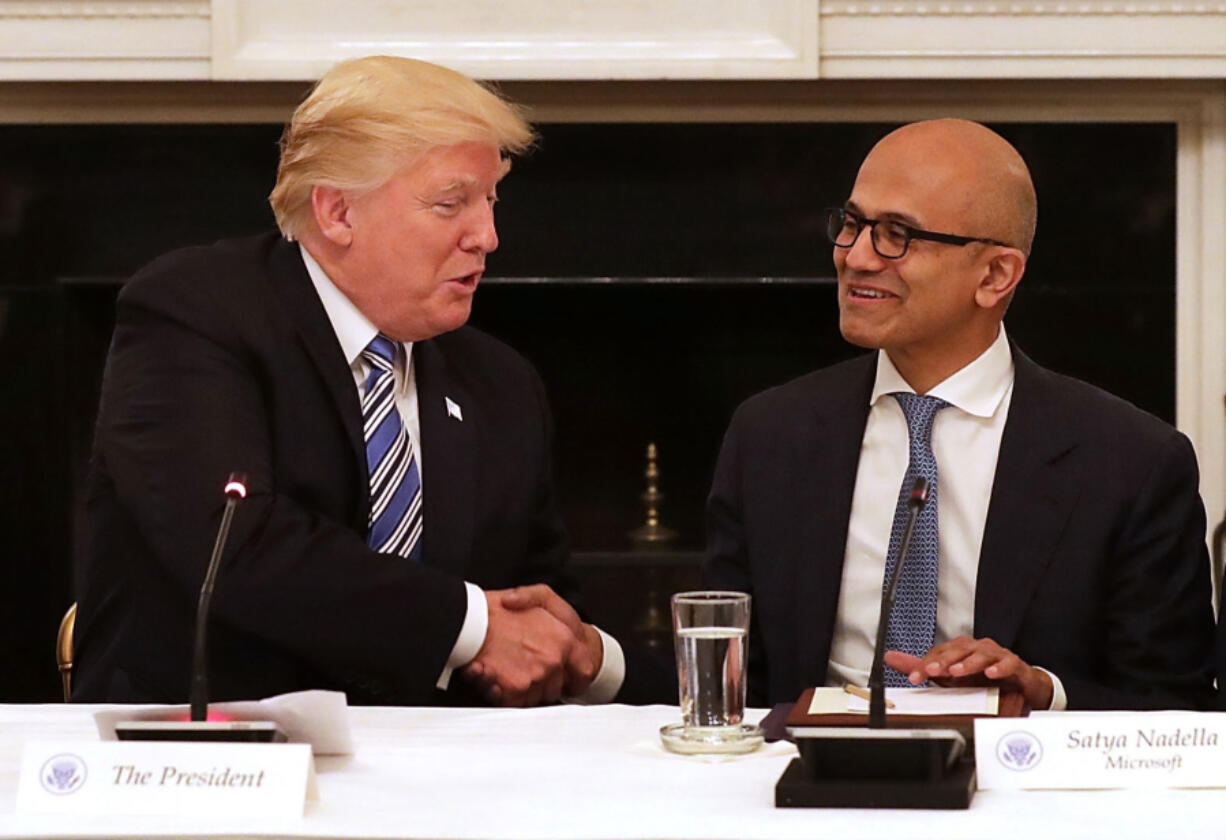 President Donald Trump, left, welcomes members of his American Technology Council, including Microsoft CEO Satya Nadella, right, in the State Dining Room of the White House June 19, 2017, in Washington, D.C.