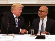 President Donald Trump, left, welcomes members of his American Technology Council, including Microsoft CEO Satya Nadella, right, in the State Dining Room of the White House June 19, 2017, in Washington, D.C.