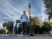 TikToker Logan Ivey stands near a street lamp on J Street in midtown Sacramento that was fixed after he featured it in a viral video. It is one of several locations that has received city attention because of his social media efforts.