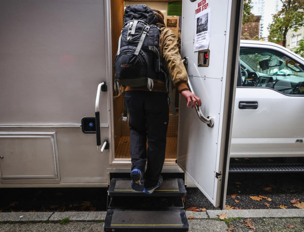 Dan, 44, climbs the steps into an Evergreen Treatment Services&Ccedil;&fnof;&Ugrave; mobile vehicle to get a dose of methadone, Monday, Oct. 28, 2024, in downtown Seattle.