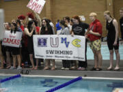 Members of the Evergreen Public Schools swim program cheer on a teammate during the 4A/3A District 4 girls swimming championships at Kelso High School on Saturday, Nov. 2, 2024.