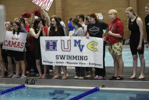 Members of the Evergreen Public Schools swim program cheer on a teammate during the 4A/3A District 4 girls swimming championships at Kelso High School on Saturday, Nov. 2, 2024.