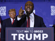 U.S. Sen. Tim Scott, R-S.C., speaks as Republican presidential candidate and former President Donald Trump looks on during a campaign rally at the Grappone Convention Center on Jan. 19, 2024, in Concord, New Hampshire.