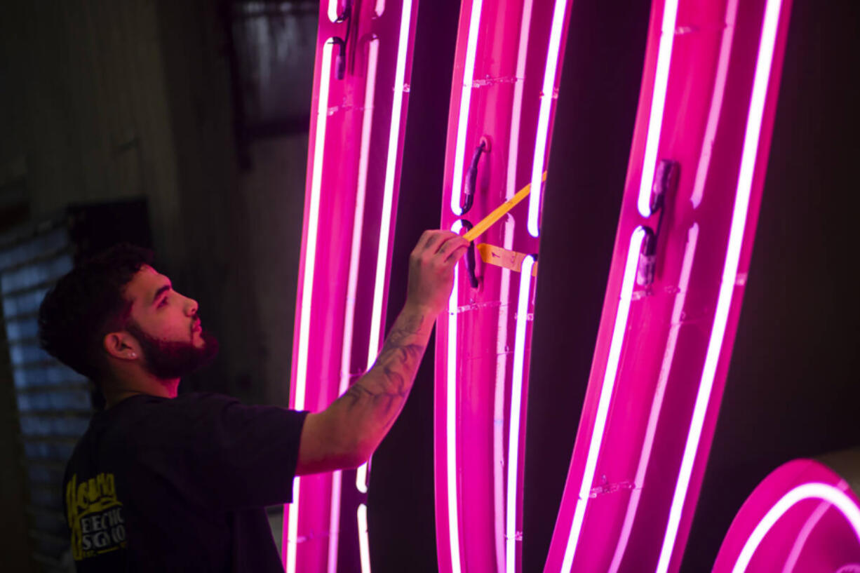 A YESCO employee checks the &ldquo;Debbie&rdquo; neon sign, from the former Debbie Reynolds Hollywood Hotel, on Sept. 17, 2024, at YESCO in Las Vegas.