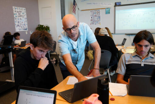 Jeff Simon (c) works with his math students Gabriel Raposo (r), 15 and Luka Esquer (l), 15 on their Intermediate Algebra classroom assignment at Sage Creek High School in Carlsbad. (Nelvin C.