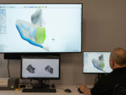 Bob Manning, senior shell design technician, demonstrates how a personalized hearing aid is modeled for an individual ear at Starkey Headquarters in Eden Prairie, Minnesota, on Thursday, Nov. 7, 2024.