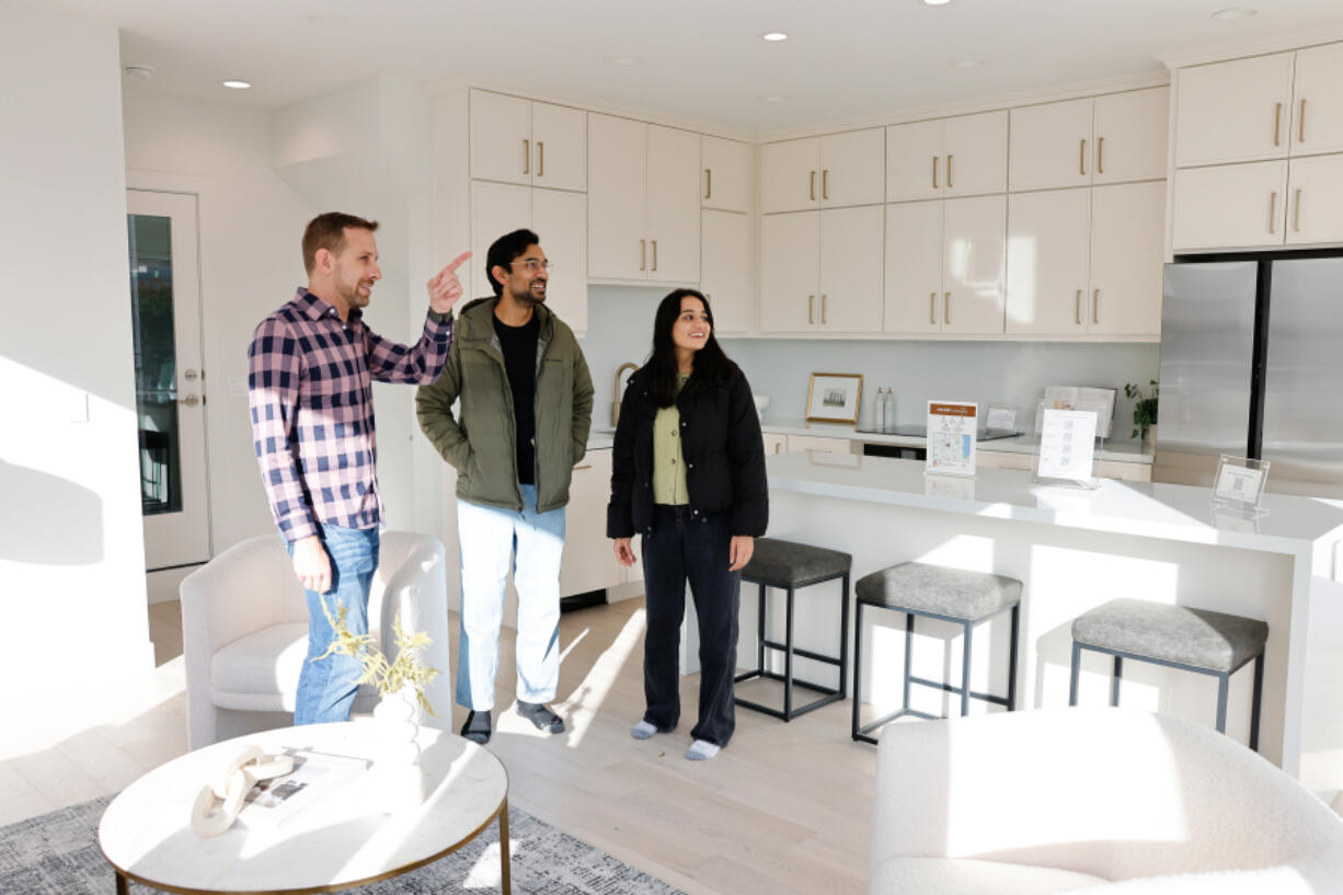 Anurag Kamasamudram, center, and Mayuri Gupta, right, look at a townhome with realtor Matt Miner, left, from Compass, a real estate company, in the Queen Anne neighborhood in Seattle on Sunday, Oct. 27, 2024. The couple has an investment house but this is their first time buying a home for themselves. &Ccedil;&fnof;&uacute;Matt&Ccedil;&fnof;&Ugrave;s helped us understand what we like and don&Ccedil;&fnof;&Ugrave;t like through the tours,&Ccedil;&fnof;&ugrave; says Mayuri. The couple is new to Seattle since May and still learning the neighborhoods. &Ccedil;&fnof;&uacute;He&Ccedil;&fnof;&Ugrave;s helping us understand what areas we want to live in too.&Ccedil;&fnof;&ugrave; she says.