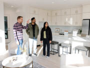 Anurag Kamasamudram, center, and Mayuri Gupta, right, look at a townhome with realtor Matt Miner, left, from Compass, a real estate company, in the Queen Anne neighborhood in Seattle on Sunday, Oct. 27, 2024. The couple has an investment house but this is their first time buying a home for themselves. &Ccedil;&fnof;&uacute;Matt&Ccedil;&fnof;&Ugrave;s helped us understand what we like and don&Ccedil;&fnof;&Ugrave;t like through the tours,&Ccedil;&fnof;&ugrave; says Mayuri. The couple is new to Seattle since May and still learning the neighborhoods. &Ccedil;&fnof;&uacute;He&Ccedil;&fnof;&Ugrave;s helping us understand what areas we want to live in too.&Ccedil;&fnof;&ugrave; she says.