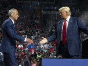 Former Republican presidential candidate Robert F. Kennedy Jr. and Republican presidential nominee, former U.S. President Donald Trump shake hands during a campaign rally at Desert Diamond Arena on Aug. 23, 2024, in Glendale, Arizona.