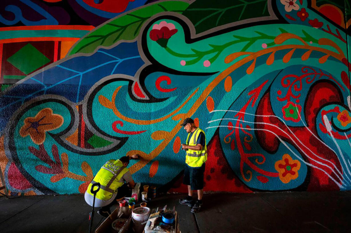 Artist Henry Fisk, aka &quot;Fisko,&quot; left, works in September with Jos&Dagger;&copy; Lott  on a mural in the Second Avenue Highway 99 underpass.