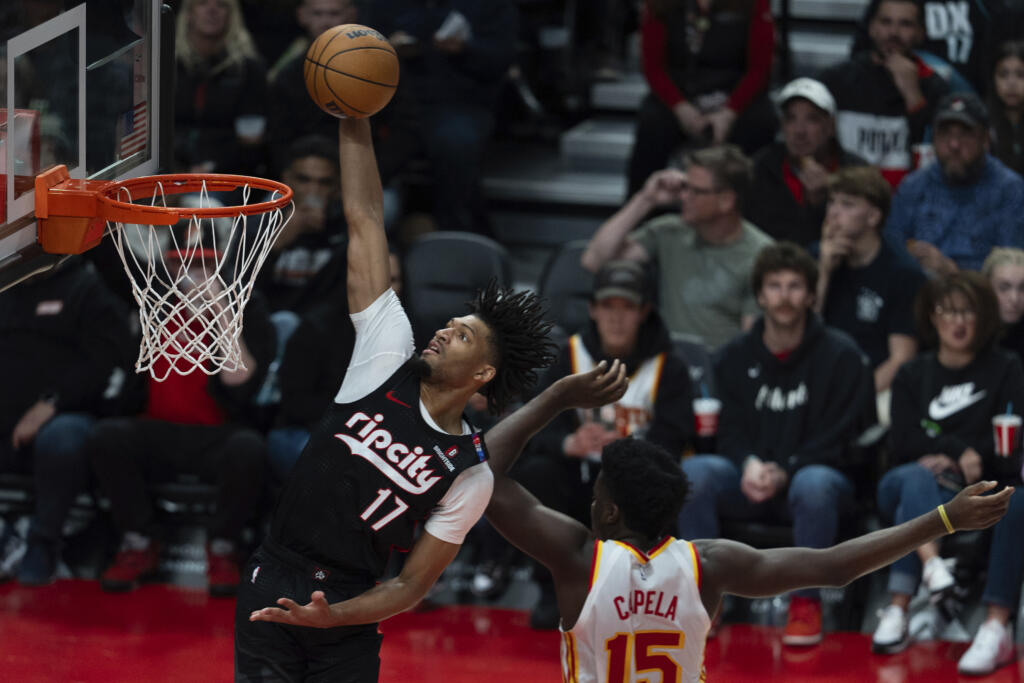 Portland Trail Blazers guard Shaedon Sharpe (17) drives to the basket as Atlanta Hawks center Clint Capela defends during the second half of an NBA basketball game, Sunday, Nov. 17, 2024, in Portland, Ore.