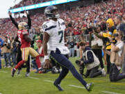 Seattle Seahawks quarterback Geno Smith (7) reacts after scoring against the San Francisco 49ers during the second half of an NFL football game in Santa Clara, Calif., Sunday, Nov. 17, 2024. (AP Photo/Godofredo A.