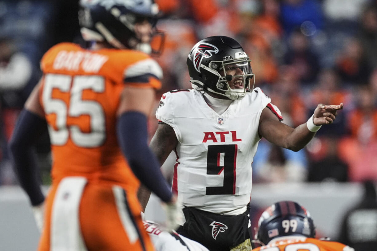 Atlanta Falcons quarterback Michael Penix Jr. (9) works against the Denver Broncos during the second half of an NFL football game, Sunday, Nov. 17, 2024, in Denver.