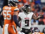 Atlanta Falcons quarterback Michael Penix Jr. (9) works against the Denver Broncos during the second half of an NFL football game, Sunday, Nov. 17, 2024, in Denver.