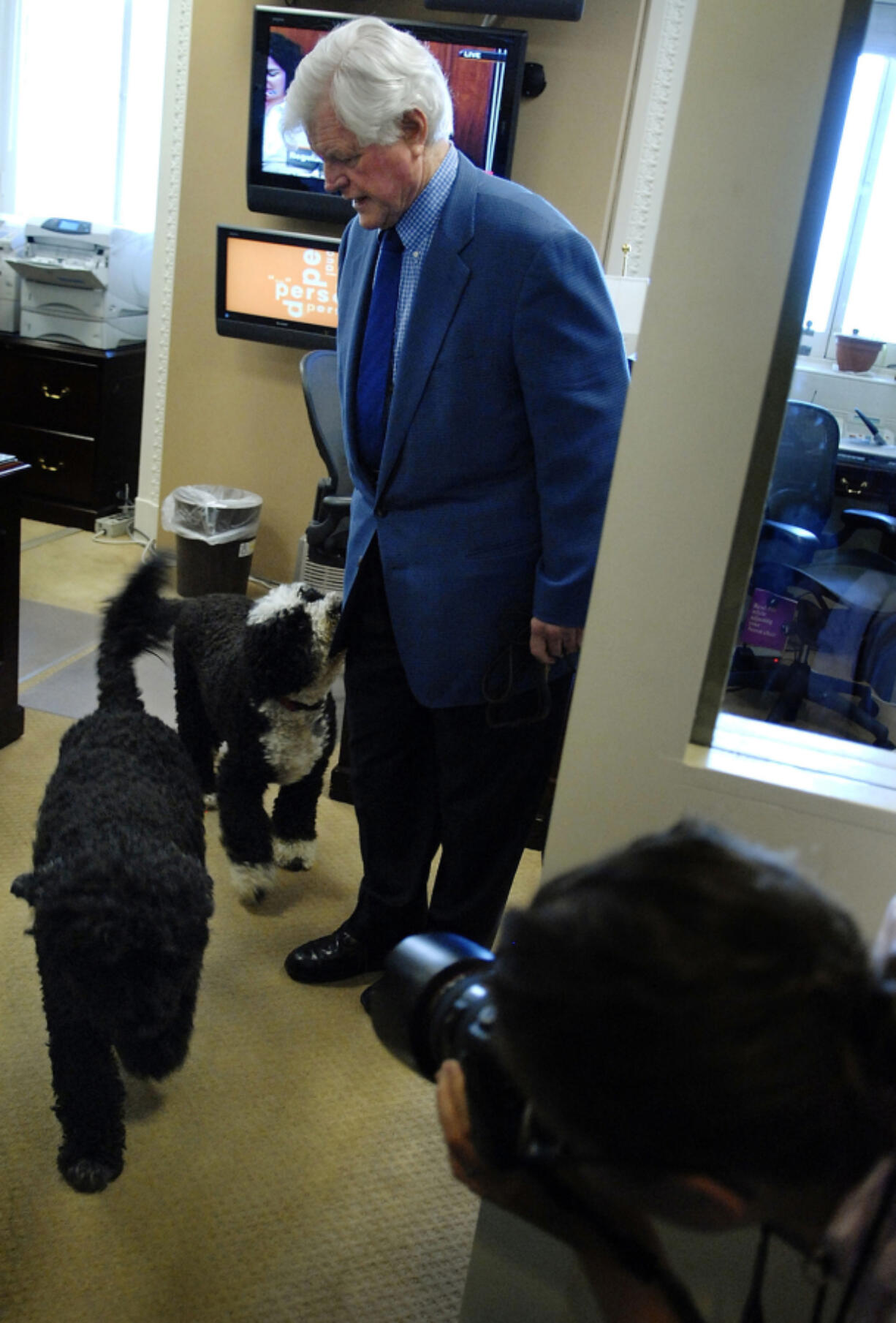 U.S. Sen. Edward Kennedy, D-Ma., wrangles his dogs to depart after a news conference about the failure of recent immigration legislation June 8, 2007, at the Capitol in Washington, D.C.