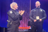 Camas Police Chief Tina Jones, left, present a medal of merit to Camas police officer Steven Forgette on May 23 at Grace Foursquare Church in Camas.