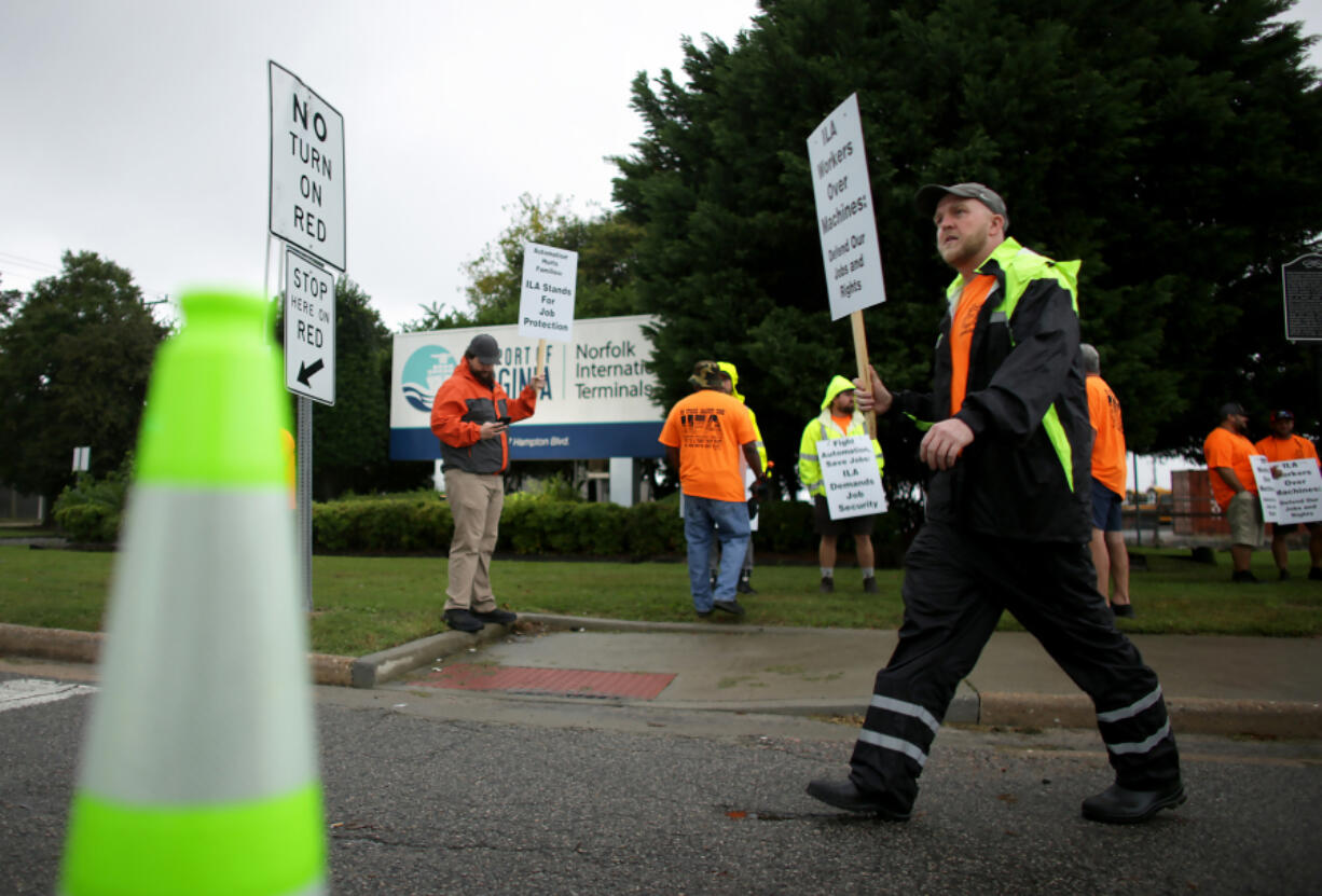 Striking ILA union members form a picket line along Hampton Boulevard outside Norfolk International Terminals on Oct. 1, 2024, in Norfolk, Virginia. (Stephen M.