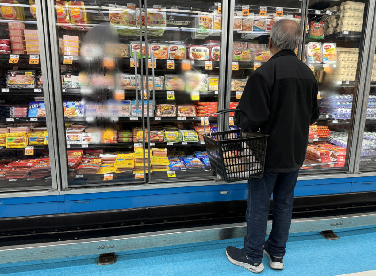 A customer shops for food at a grocery store on March 12, 2024, in San Rafael, California.