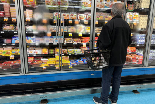 A customer shops for food at a grocery store on March 12, 2024, in San Rafael, California.