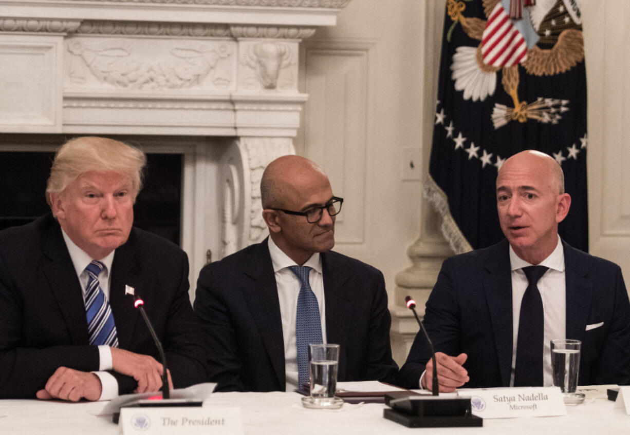 President Donald Trump, left, and Microsoft CEO Satya Nadella listen to Amazon CEO Jeff Bezos, right, during an American Technology Council roundtable at the White House in Washington, D.C., on June 19, 2017.